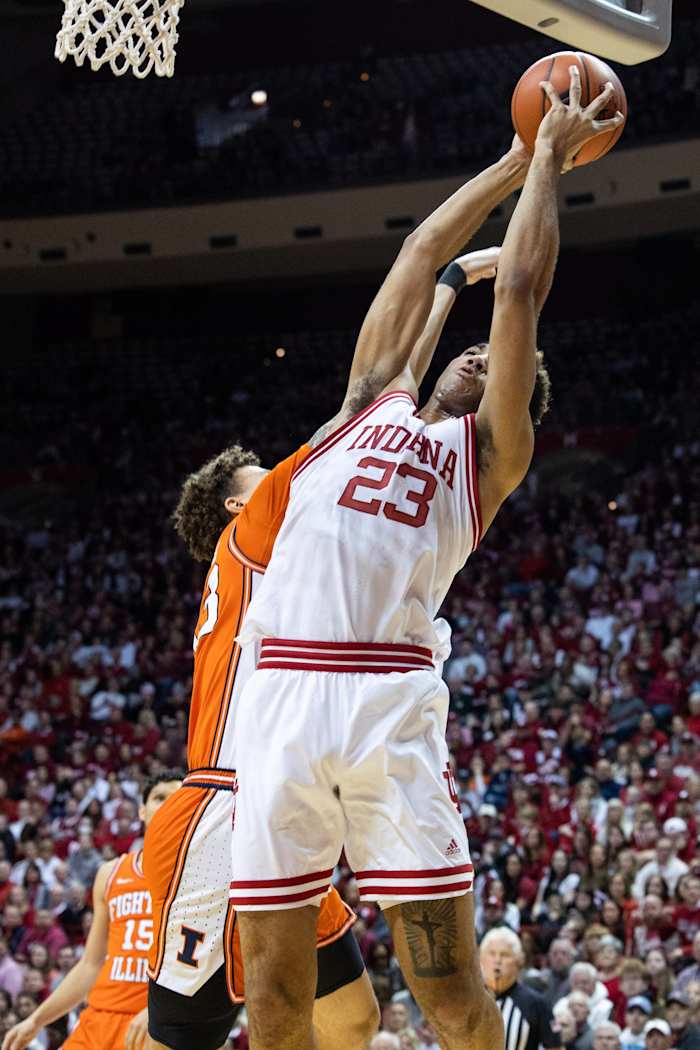 Trayce Jackson-Davis (23) shoots the ball while Illinois Fighting Illini forward Coleman Hawkins (33) defends.